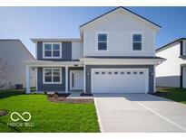 Charming two-story home features a spacious two-car garage and well-manicured lawn at 1573 Hanover St, Danville, IN 46122