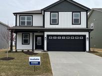 Two-story home featuring white siding, black trim, and a two-car garage at 1579 Hanover St, Danville, IN 46122