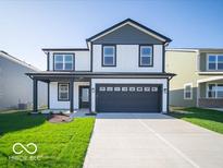 Two-story home featuring white siding, dark gray trim, a front porch, and an attached two-car garage at 1579 Hanover St, Danville, IN 46122