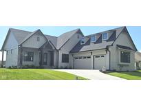 Charming single-Gathering home with a manicured lawn, two-car garage and inviting front entry at 16298 Grand Cypress Dr, Noblesville, IN 46060