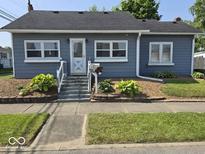Charming single-story home with well-maintained front yard, steps, and landscaping at 1517 N E St, Elwood, IN 46036