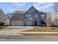 Charming two-story home with brick and siding, a two-car garage, and a well-maintained front yard at 12997 Bartlett Dr, Fishers, IN 46037