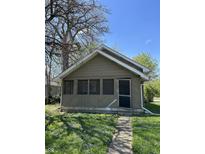 Charming home with a quaint front yard featuring green grass and the walkway to the front door on a sunny day at 2270 Wheeler St, Indianapolis, IN 46218