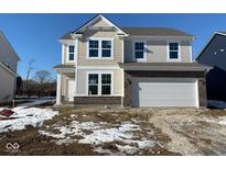 Two-story home boasts mixed siding, brick details, and a two-car garage for modern curb appeal at 1166 Stubble Run, Danville, IN 46122
