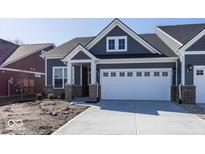 Charming home featuring a two-car garage, stylish gray siding, and a welcoming front porch at 3917 Holly Brook Dr, Westfield, IN 46062