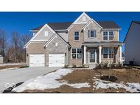 Two-story brick home with a large front porch and attached two-car garage at 4958 Reavie Ct, Noblesville, IN 46062