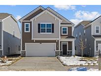 Two-story home with brown siding, stone accents, and an attached two-car garage at 5127 Rolling Meadow Blvd, Indianapolis, IN 46237