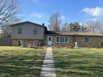 Exterior shot of a two-story home with a well-maintained lawn and walkway at 406 S Fenton Ave, Indianapolis, IN 46219