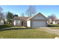 Charming single-story home with a two-car garage and well-maintained lawn on a sunny day at 5250 Shamus Dr, Indianapolis, IN 46235
