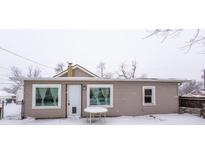 Tan house with white windows and door in snowy yard at 64 S 10Th Ave, Beech Grove, IN 46107