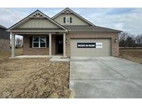 Brick ranch home with attached garage and covered porch, move-in ready at 1390 Foxtail Ln, Greenwood, IN 46143