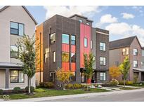 Modern three-story home with brick and metal siding, showcasing a stylish design at 1825 N New Jersey St, Indianapolis, IN 46202