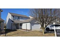 Charming two-story home with gray siding, attached garage, and well-kept lawn at 4056 Orchard Valley Ln, Indianapolis, IN 46235