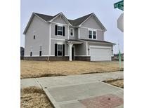 New two-story home featuring gray siding, black shutters, and a two-car garage, complemented by a neatly landscaped yard at 482 Chester Ln, Pittsboro, IN 46167