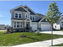 Charming two-story home with gray siding, black shutters, a manicured lawn, and a two-car garage at 4991 Elaine Ct, Noblesville, IN 46062