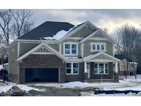 Two-story craftsman style home with brick and siding exterior, and a three-car garage at 6959 Oakdale Ln, Avon, IN 46123