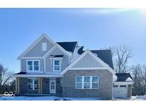 Two-story home with gray siding, brick accents, and a three-car garage at 6973 Oakdale Ln, Avon, IN 46123