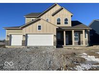 Two-story home with a three-car garage, attractive beige siding and a professionally landscaped yard at 770 Leila Mae Ln, Westfield, IN 46074