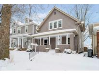 Charming 2-story home with snowy front yard at 1715 Union St, Indianapolis, IN 46225