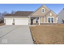 Charming single-Gathering home showcasing a three-car garage and manicured lawn at 310 N Bur Oak Dr, Mooresville, IN 46158
