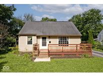 Charming single-story home featuring a cozy front deck and a well-maintained lawn at 6348 Kingsley Dr, Indianapolis, IN 46220