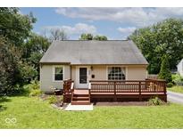 Charming single-story home with a front porch, lovely landscaping, and a well-maintained lawn at 6348 Kingsley Dr, Indianapolis, IN 46220