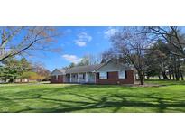 Charming single-story home with a well-maintained lawn and inviting front porch at 965 W New Rd, Greenfield, IN 46140