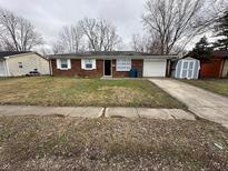 Brick ranch home with attached garage and storage shed at 10119 Catalina Dr, Indianapolis, IN 46235