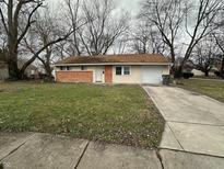 Brick and vinyl ranch home with attached garage and spacious yard at 3940 N Webster Ave, Indianapolis, IN 46226