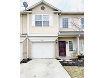 Charming townhome featuring a single-car garage, well-maintained lawn, and large windows at 5576 Nighthawk Dr, Indianapolis, IN 46254