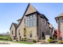 Brick home with a modern design, featuring a large window and landscaping at 583 Exmoor Dr, Carmel, IN 46032