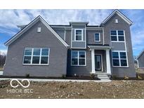 Charming two-story home with gray brick, white trim and a welcoming front porch at 6596 Dogwood Dr, McCordsville, IN 46055