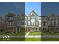 Attractive townhomes featuring varied facades, professionally landscaped lawns and welcoming entrance doors at 7344 W County Road 600, McCordsville, IN 46055