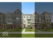 View of new townhomes showcasing brick and siding exteriors, complemented by well-maintained lawns and inviting walkways at 7348 W County Road 600 Rd # 12-604, McCordsville, IN 46055