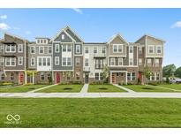 Charming townhomes featuring diverse facades and lush landscaping enhancing curb appeal at 7348 W County Road 600 Rd # 12-604, McCordsville, IN 46055