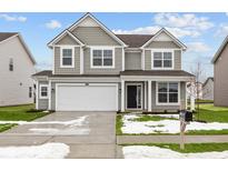 Charming two-story home showcasing a well-manicured lawn and a two car garage at 10121 Redwood Peak Ln, Indianapolis, IN 46259