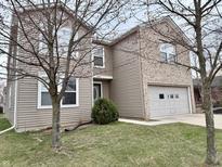 Two-story home featuring a combination of siding and brick, an attached garage, and a well-maintained lawn at 15314 Clear St, Noblesville, IN 46060