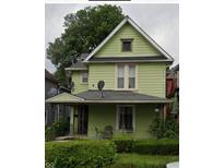 Light green two-story house with a front porch and a well-maintained lawn at 2434 N Kenwood Ave, Indianapolis, IN 46208