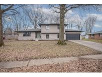 Updated ranch home with stone accents and a two-car garage at 621 Mellowood Dr, Indianapolis, IN 46217