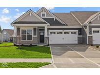 Charming single-Gathering home featuring a two-car garage, stone accents, and a well-manicured lawn at 3509 Wrangler Dr, Bargersville, IN 46106
