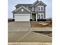 Charming two-story home featuring gray siding, white trim, an attached two-car garage, and a concrete driveway at 207 Ambassador Dr, Pittsboro, IN 46167