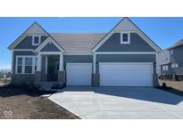 Charming home featuring a two-car garage, covered entry and appealing architectural details at 6260 Stone Side Dr, Plainfield, IN 46168
