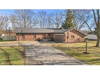 Brick ranch home with attached garage and driveway at 4151 Senour Rd, Indianapolis, IN 46239