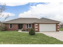 Charming single-story red brick home with an attached two-car garage and well-maintained lawn at 4208 E Epler Ave, Indianapolis, IN 46237