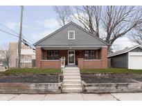 Brick home with gray accents, steps, and landscaping at 726 E 54Th St, Indianapolis, IN 46220
