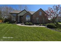 Beautiful brick home with a manicured lawn and landscaping, featuring a charming front walkway at 8429 Admirals Cv, Indianapolis, IN 46236