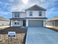 Charming two-story home with a gray garage door, covered porch and manicured front lawn at 3211 W Keepsake Ln, Monrovia, IN 46157