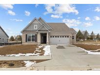 Charming single-story brick home with a two-car garage and well-manicured front yard, creating a welcoming curb appeal at 5006 Carmine St, Brownsburg, IN 46112