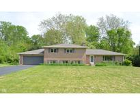 Charming brick home with well-manicured lawn and gray shutters at 7027 Creekside Ln, Indianapolis, IN 46220