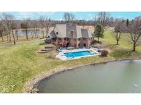 Aerial view showcasing a large in-ground pool, slide, and pond, perfect for outdoor fun and relaxation at 3592 W Smokey Row Rd, Bargersville, IN 46106